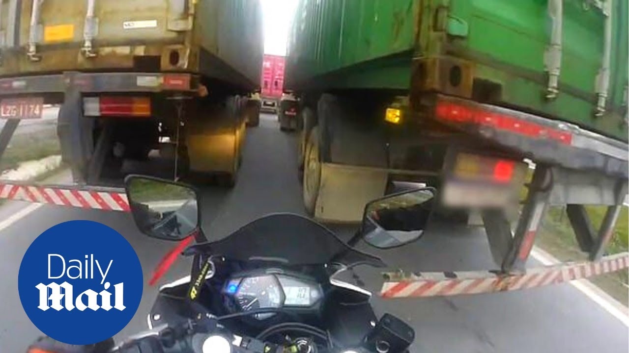 Impatient biker's close call trying to ride motorcycle between two ...