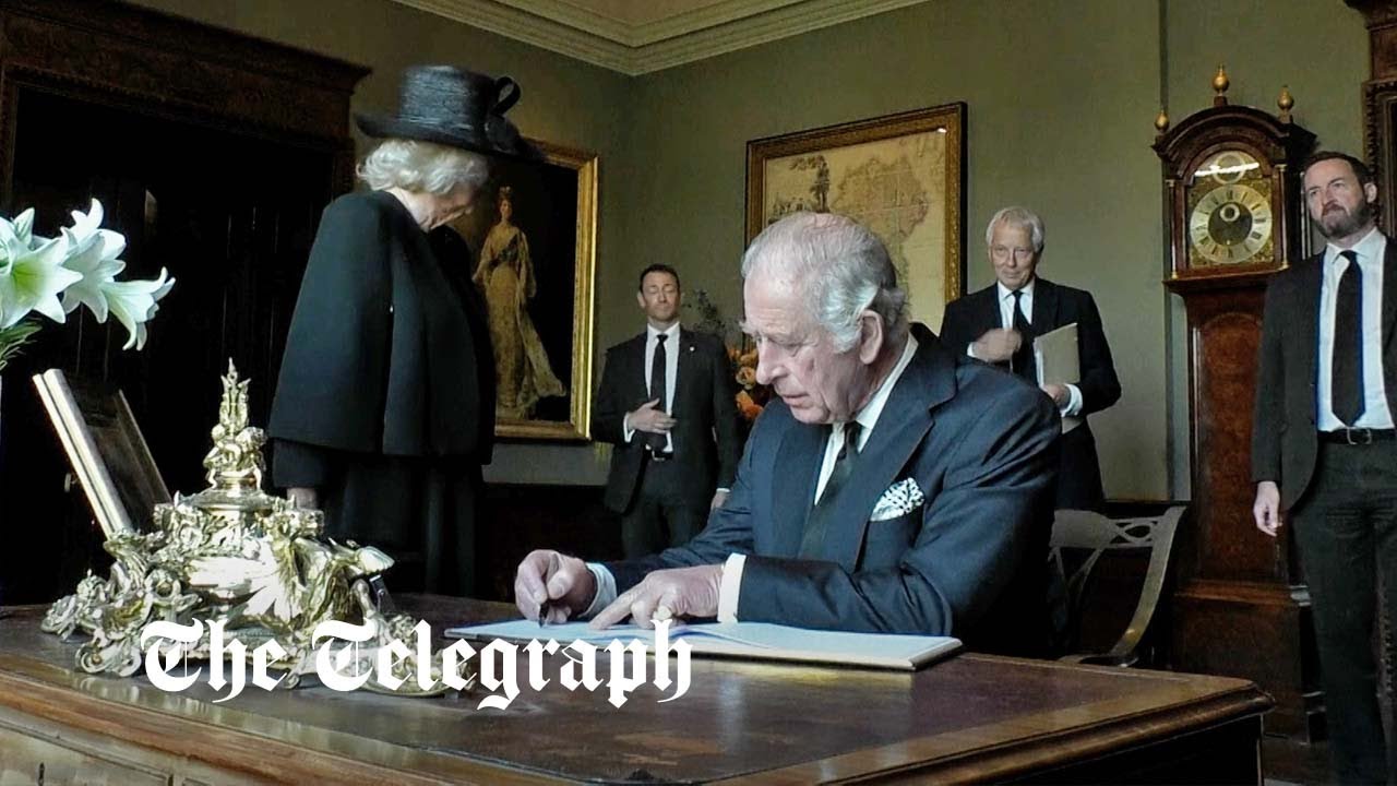 King Charles III signs Hillsborough Castle visitors book with leaking