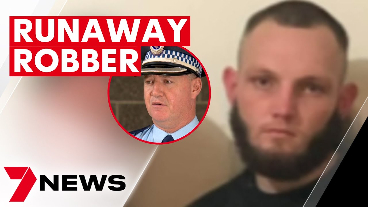 Police officers tackle alleged gunman after Carnes Hill robbery 7NEWS