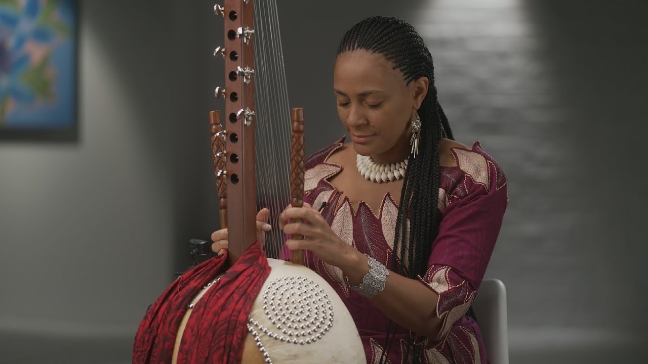 Playing the complex West African instrument called the kora 60