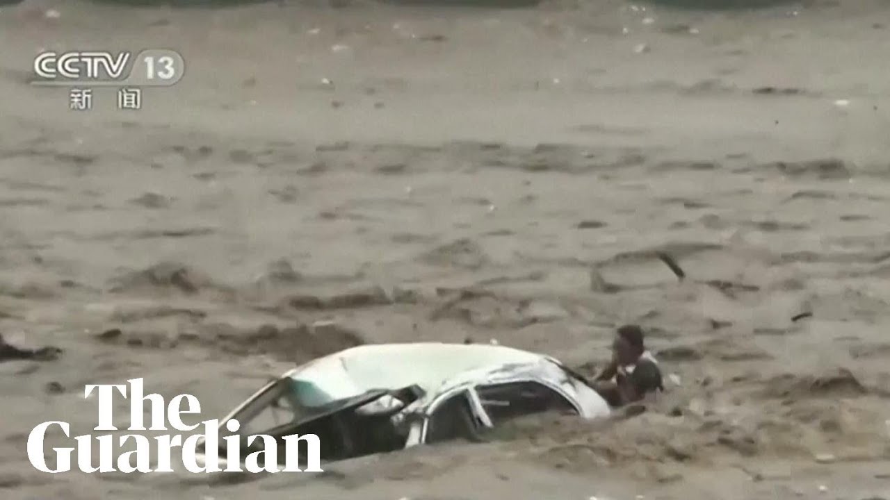 Man rescued from car swept into river as Typhoon Doksuri hits China ...